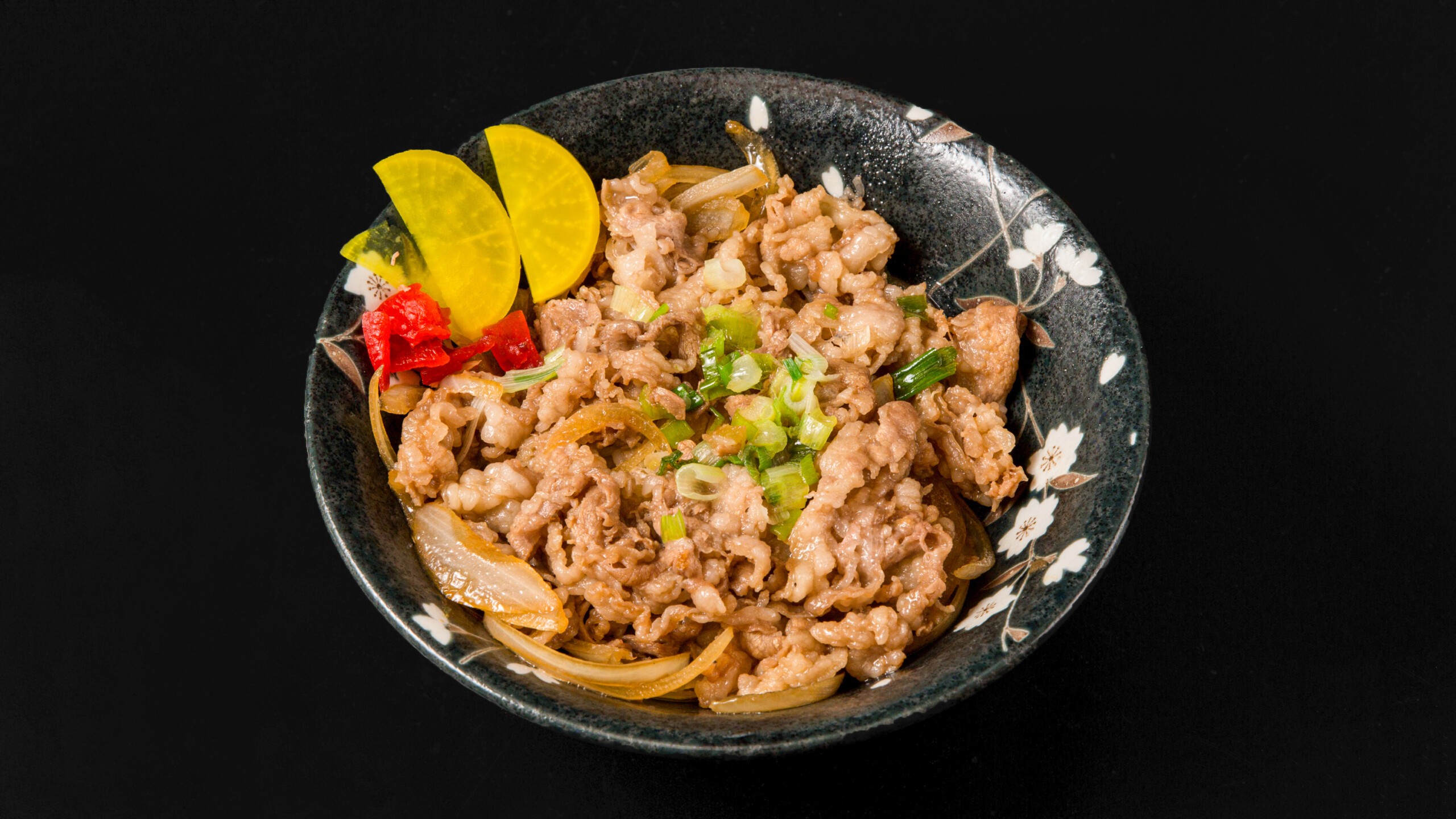 Beef bowl with onions, green onions, pickles at Wafuu Izakaya, a Japanese Restaurant in Forest Hills